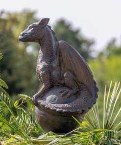 Statue of a dragon on a sphere in antique black reconstituted stone 85cm